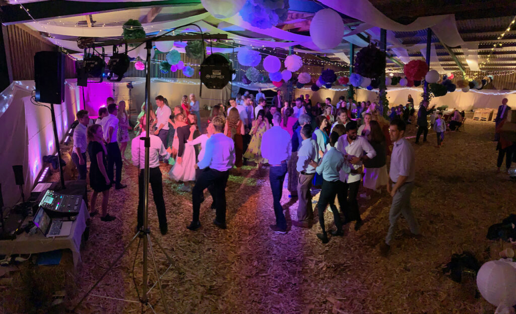 A crowd dancing at a wedding reception in a barn near Whimple, Devon