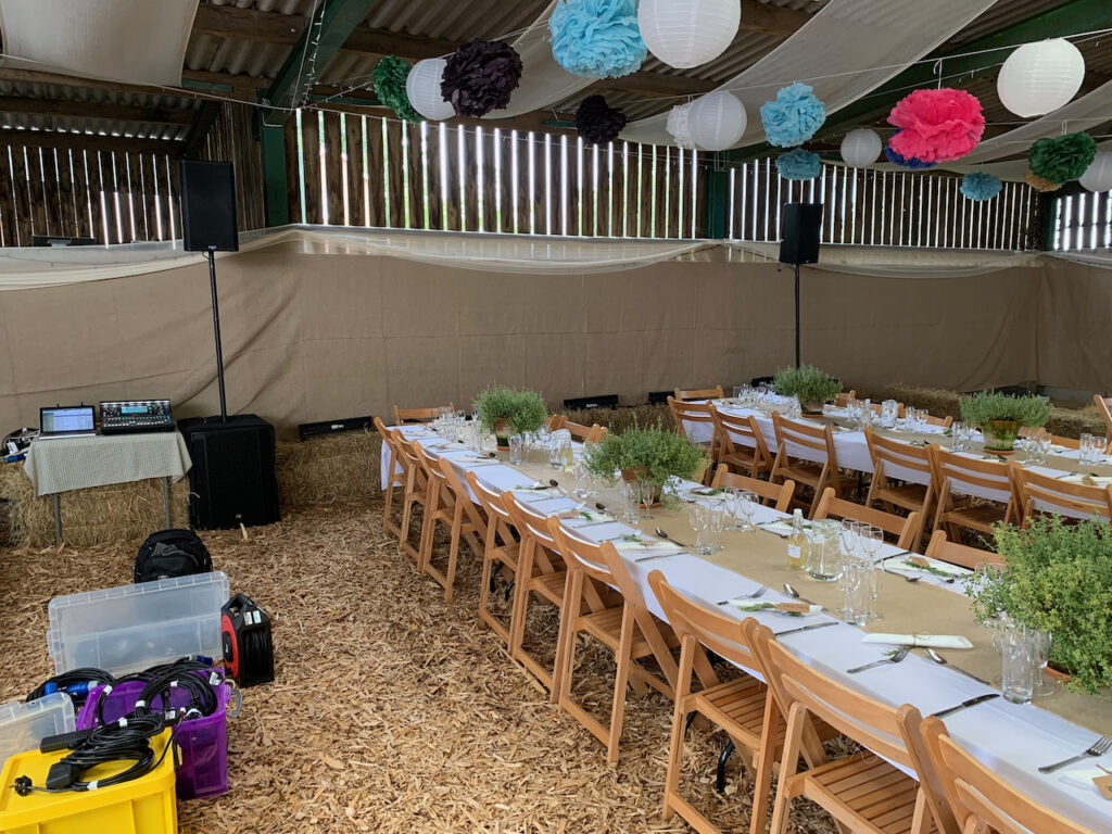 A PA system at a wedding reception in a barn at Cotley Farm, ready for speeches, a band and a DIY disco